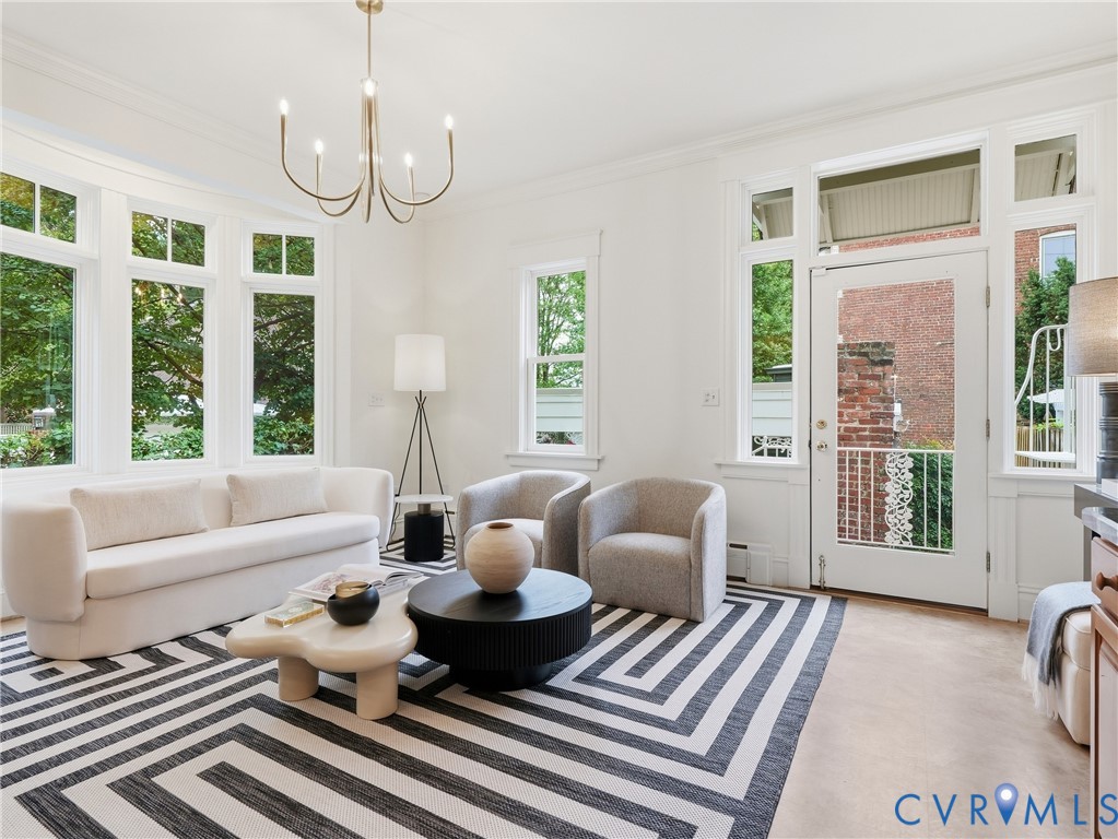 Recessed lighting, crown molding, and large bay windows with paneled walls