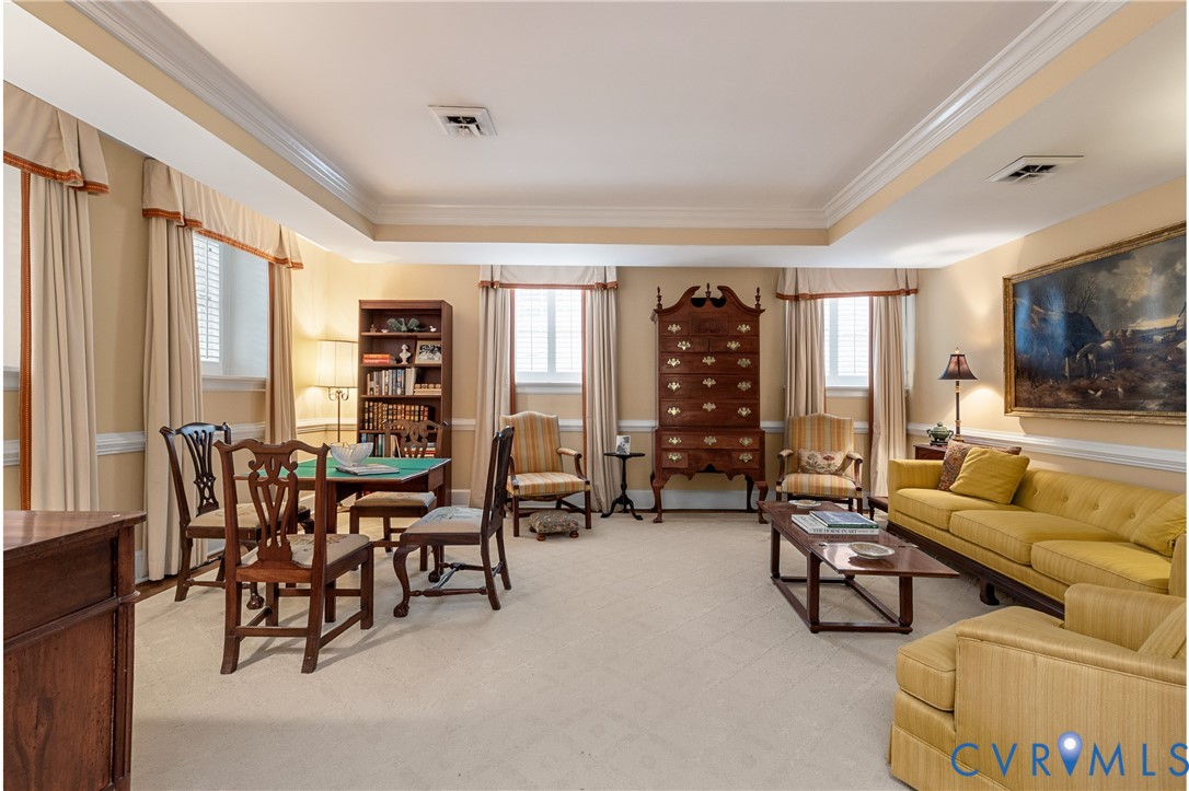 Tray ceiling, crown molding, chair rail molding, and multiple windows with integrated shutters