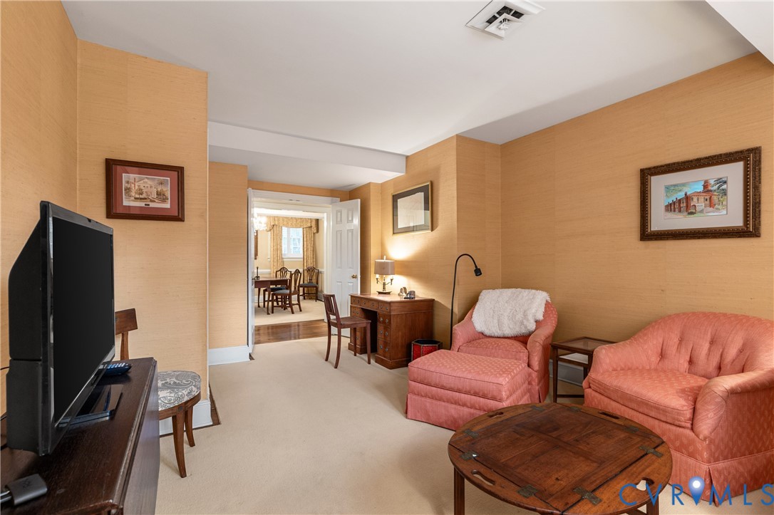 Room featuring textured wall coverings, neutral carpeting, and multi-panel interior doors