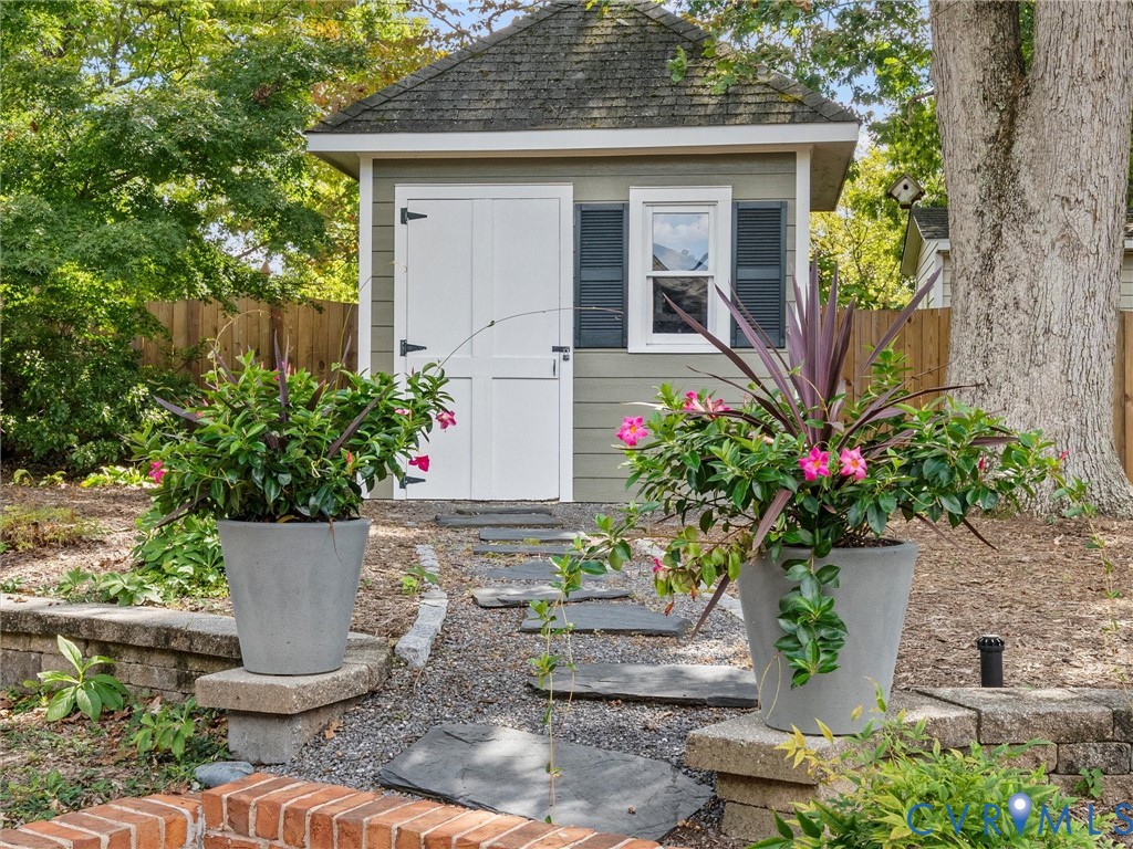 Gabled roof structure featuring a window with shutters and double doors