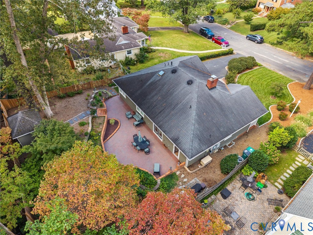 Expansive brick patio, established landscaping, privacy fencing, and a detached shed structure