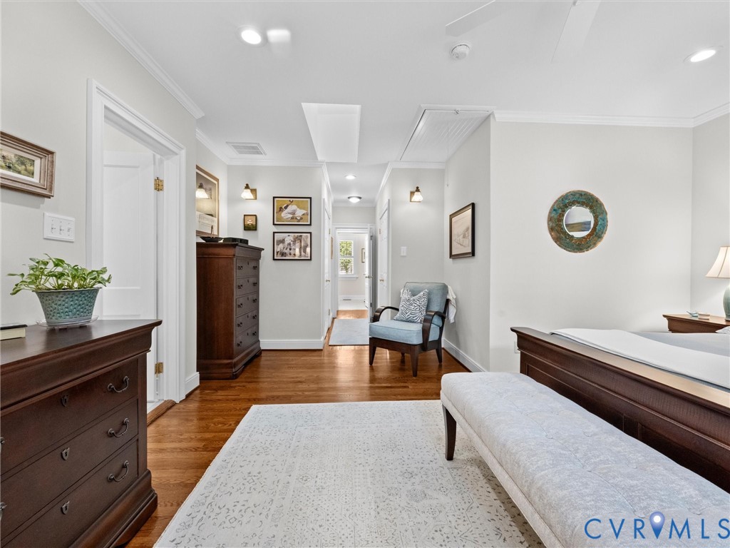 Hardwood flooring, recessed lighting, crown molding, ceiling fan, and wall sconces