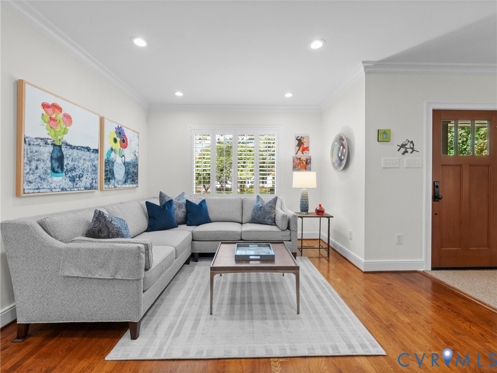 Wood-finish flooring throughout, recessed lighting, crown molding, and plantation shutters