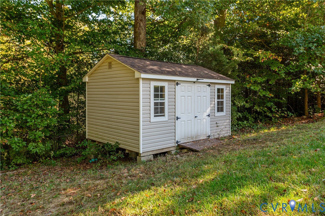 Outdoor Shed with Double Doors and Ramp to accommodate a Riding Mower