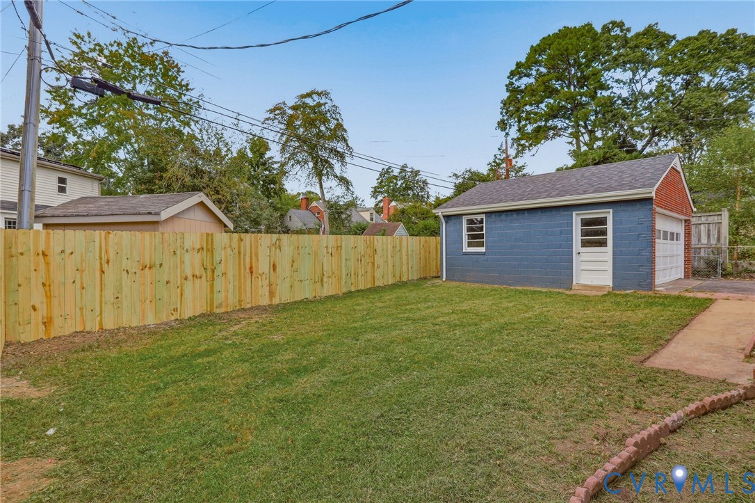 Expansive lawn area with a newly installed wooden privacy fence