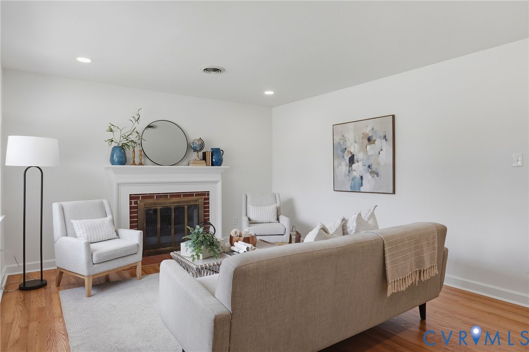 Fireplace with a white mantel and red brick surround