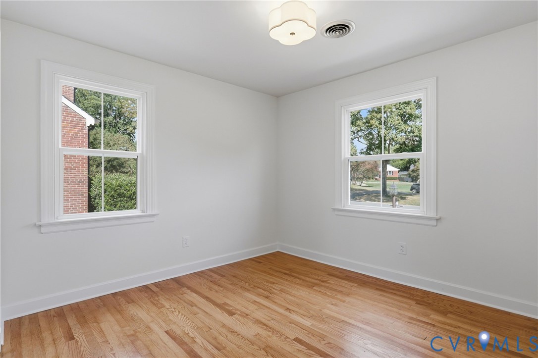 Warm wood-finish flooring with white trim