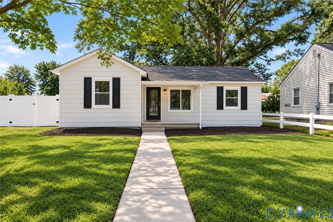 White siding exterior with black window shutters White siding exterior with black window shutters