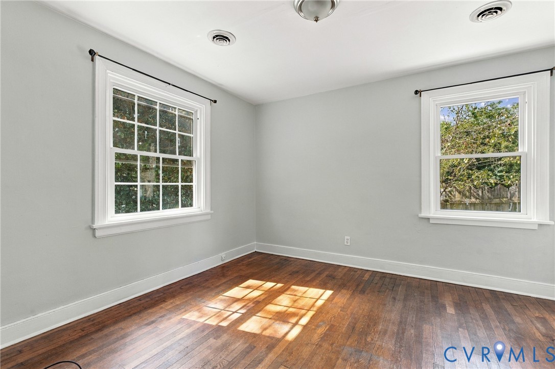 Wood-finish flooring, white trim, recessed lighting, and dual windows Wood-finish flooring, white trim, recessed lighting, and dual windows