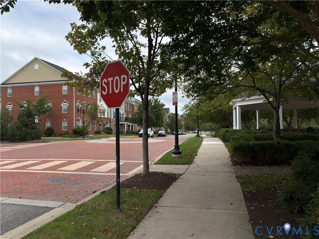 Brick paver street with crosswalks, sidewalk, and streetlights