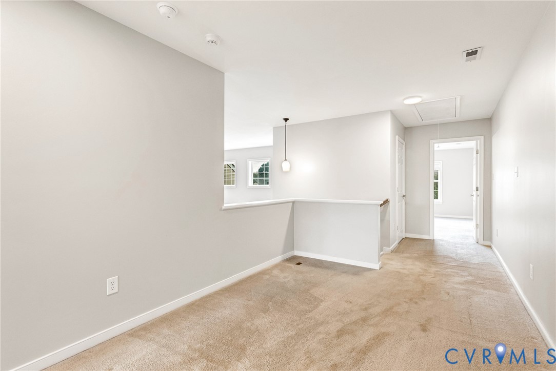 Neutral-toned walls complement plush carpeting