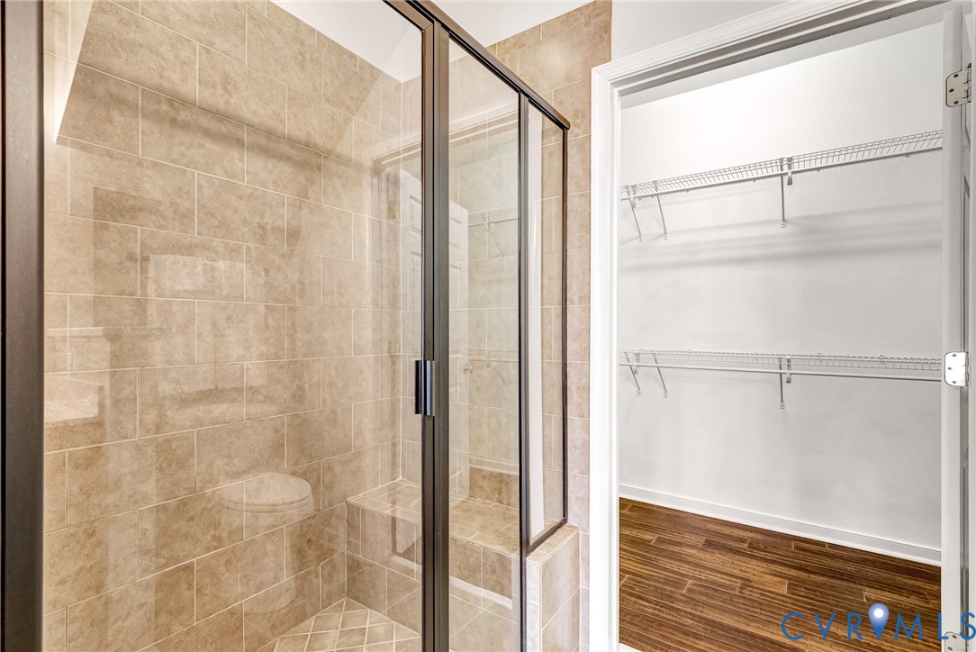 Tiled shower enclosure with a built-in bench and glass door