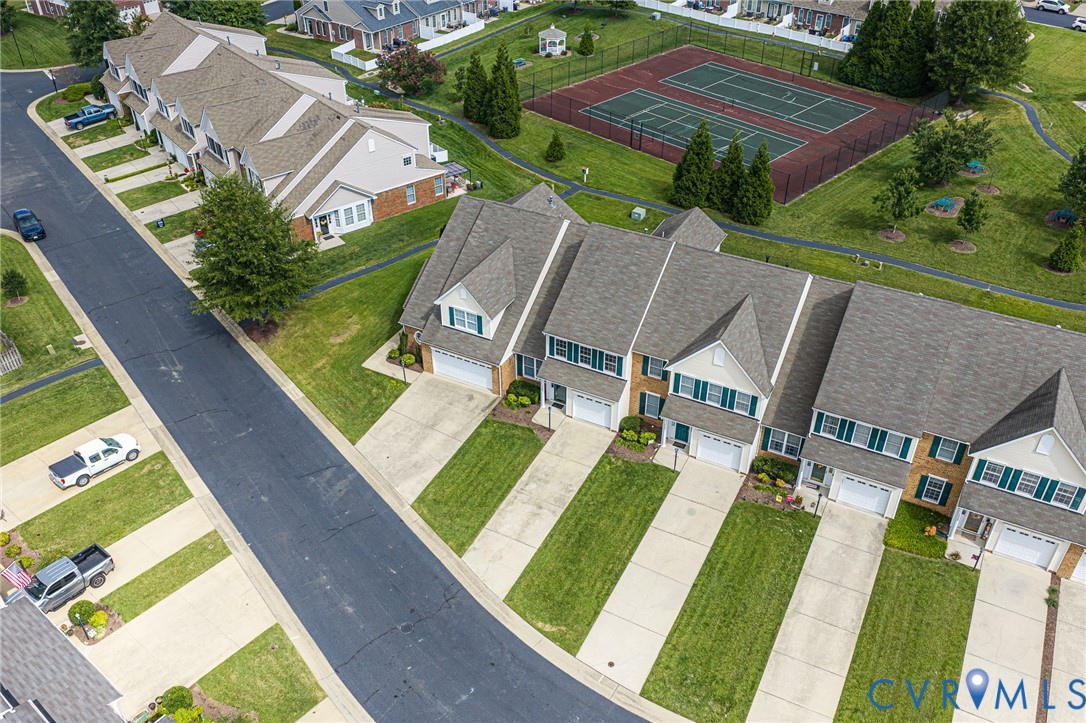 Townhomes featuring brick and siding exteriors, attached garages, and individual driveways