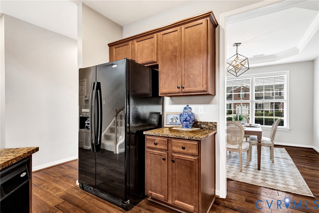 Hardwood-style flooring throughout, full-size refrigerator, built-in cabinetry, and granite-style countertops Hardwood-style flooring throughout, full-size refrigerator, built-in cabinetry, and granite-style countertops