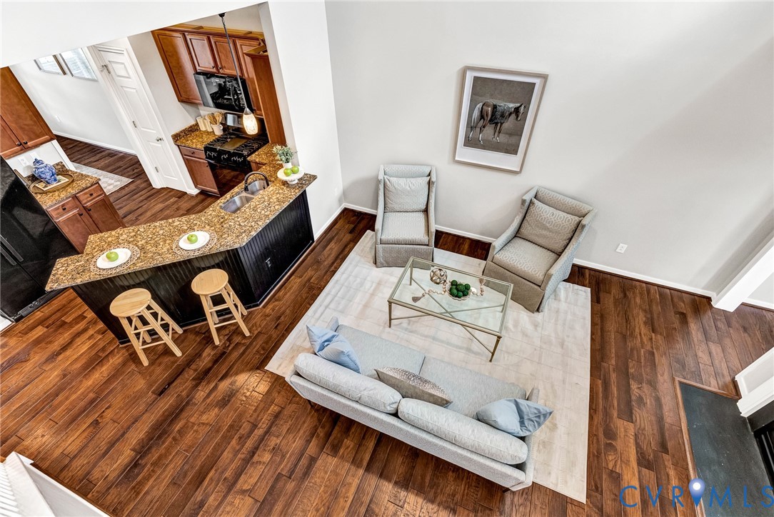 Open-concept layout featuring rich wood-finish flooring