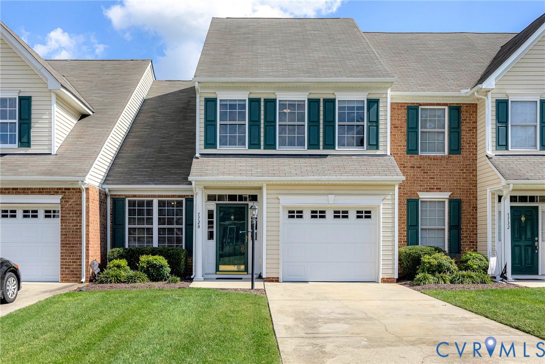 Siding and brick exterior with a pitched roof, attached garage, and a concrete driveway Siding and brick exterior with a pitched roof, attached garage, and a concrete driveway