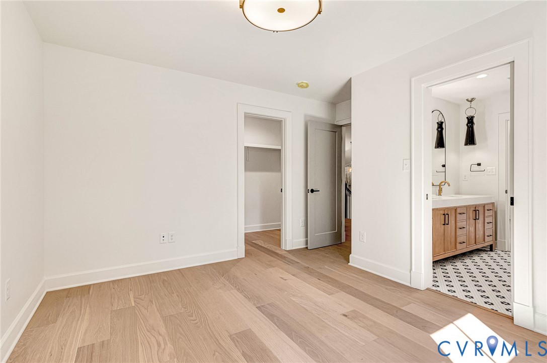 Interior space featuring wood-finish flooring, a flush-mount circular ceiling light, and interior solid-core doors