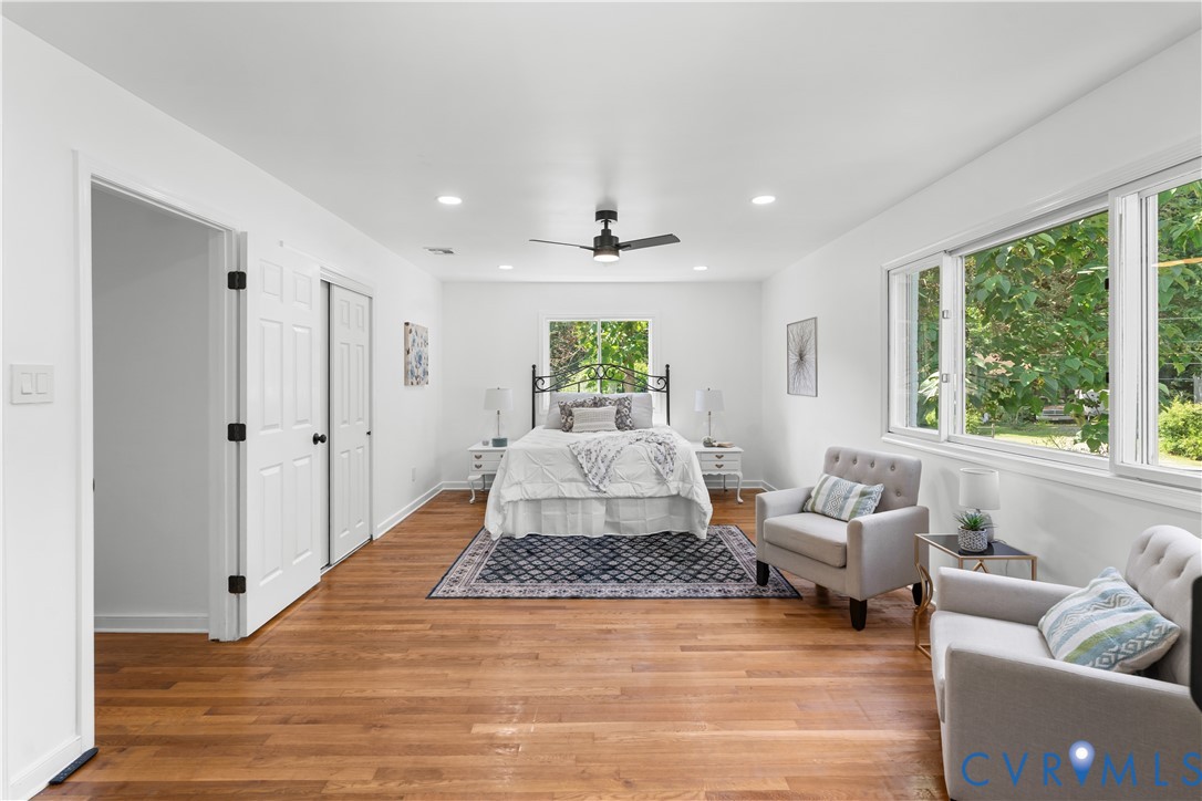 Recessed lighting, wood-finish flooring, white paneled doors, and multiple windows Recessed lighting, wood-finish flooring, white paneled doors, and multiple windows