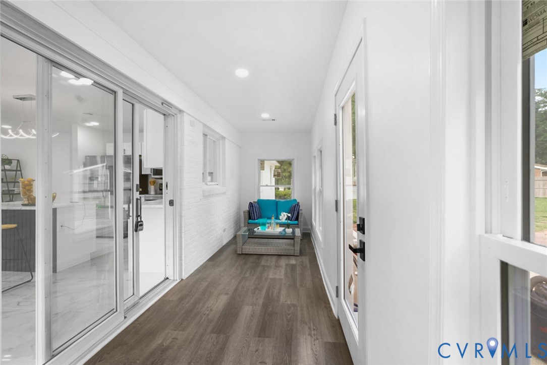 Wood-finish flooring with white walls and recessed lighting