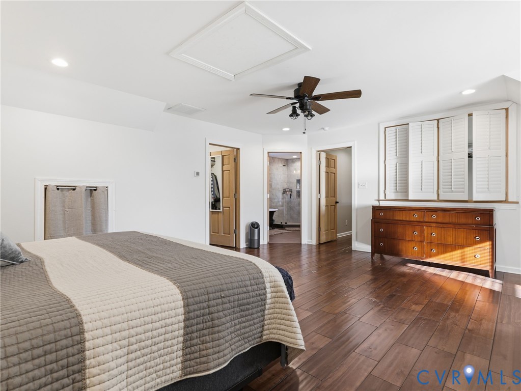 Wood-finish flooring, recessed lighting, ceiling fan with light fixture, and plantation shutters
