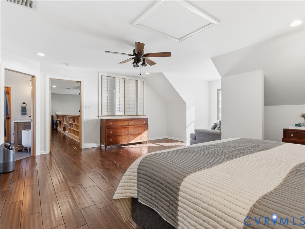 Wood-finish flooring, ceiling fan with integrated lighting, recessed lighting, and white plantation shutters