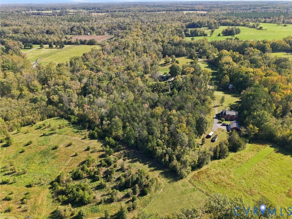 Expansive acreage featuring mature woodland, open pastoral fields, and a private gravel drive