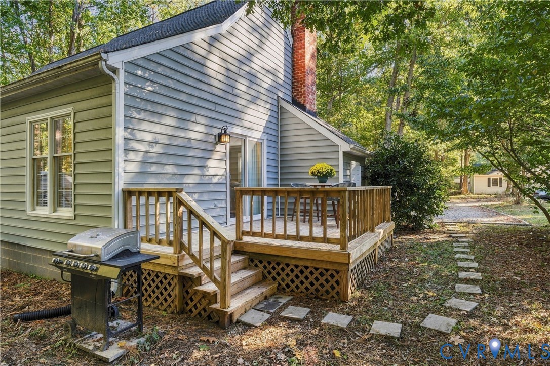 A peaceful backyard setting with a deck surrounded by mature trees