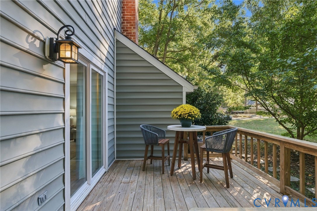 Extend your living space outdoors with a wooden deck overlooking the yard
