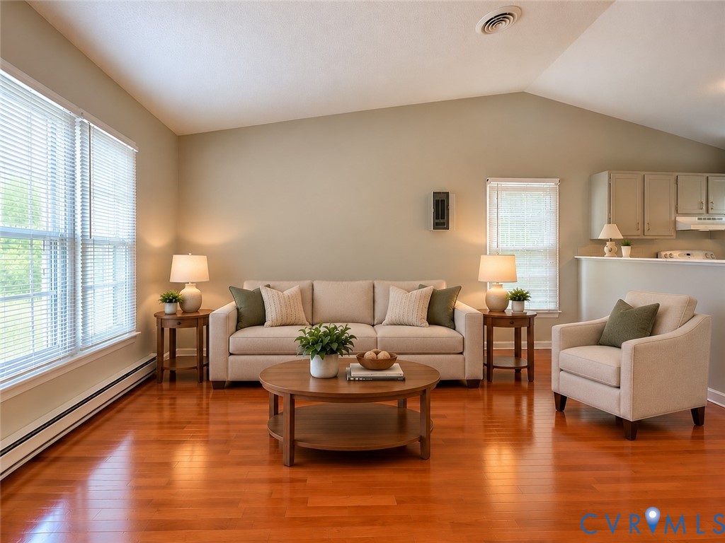 Vaulted ceilings, wood-finish flooring, and natural light from multiple windows Vaulted ceilings, wood-finish flooring, and natural light from multiple windows