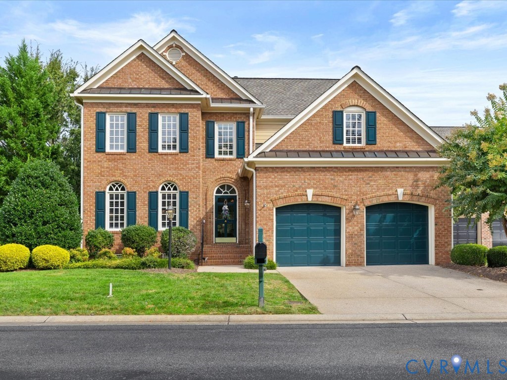 Brick exterior with an arched entryway, gabled rooflines, and a two-car garage Brick exterior with an arched entryway, gabled rooflines, and a two-car garage