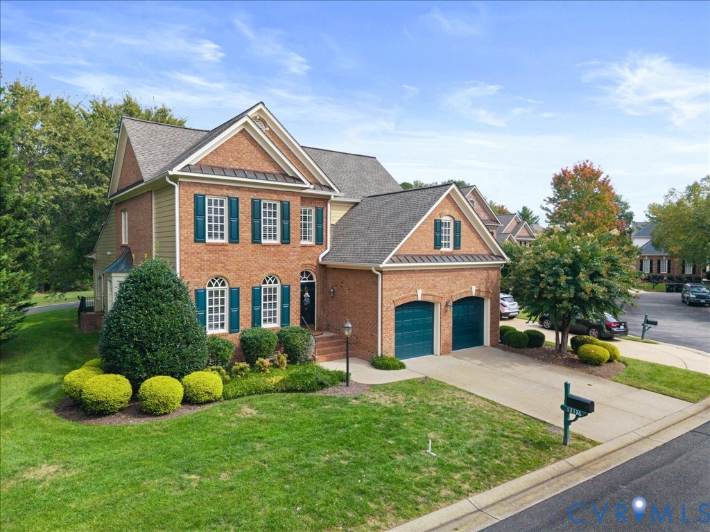 Brick exterior with gabled roof lines, white window frames, and blue shutters Brick exterior with gabled roof lines, white window frames, and blue shutters