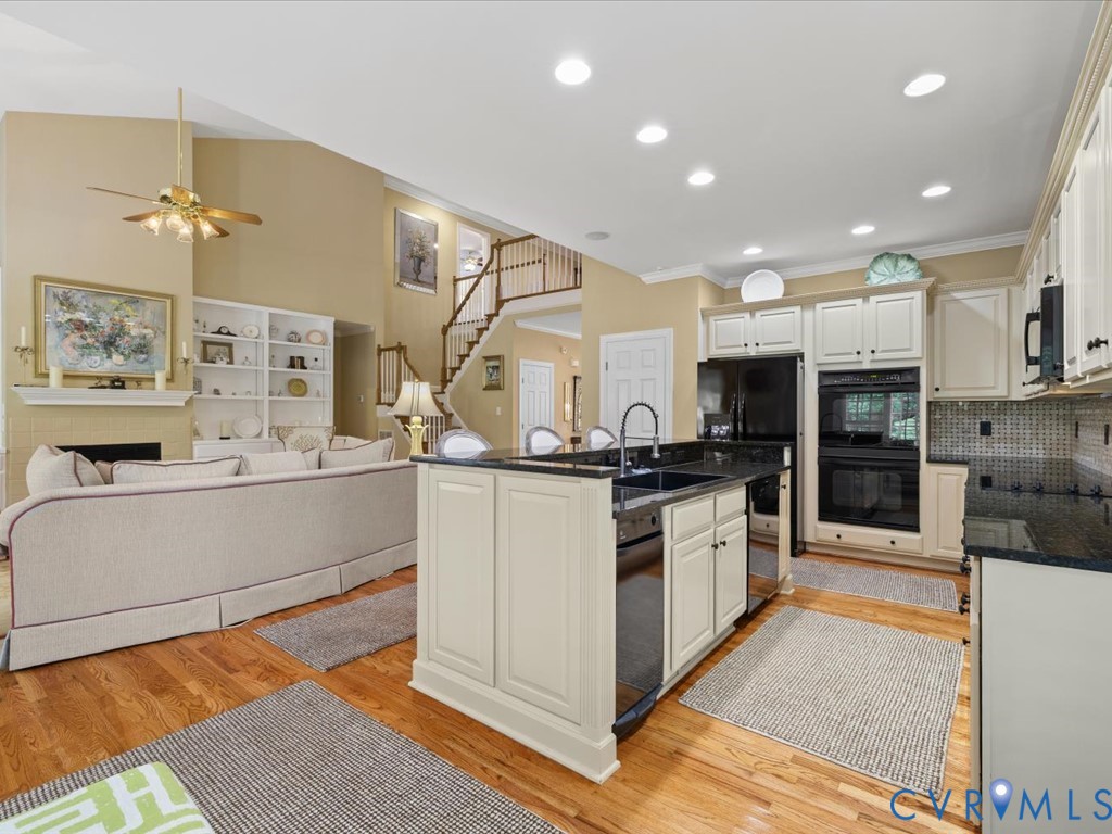 Kitchen featuring dark countertops, cream cabinetry, and a built-in oven