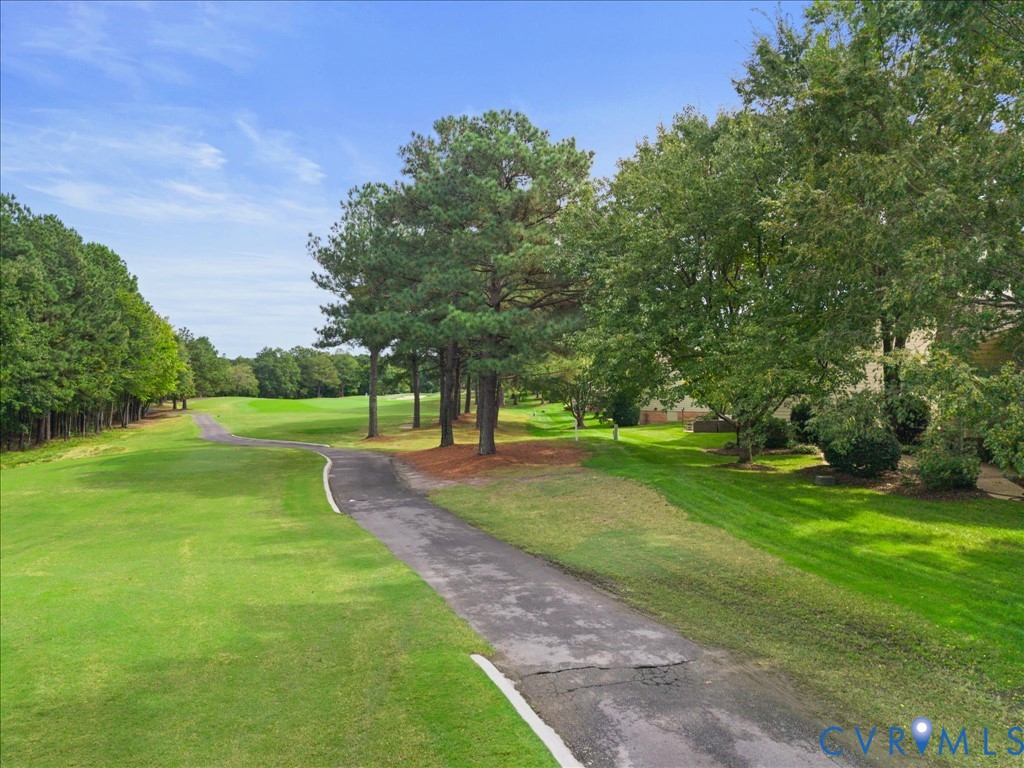 Expansive green spaces with mature trees and paved pathways