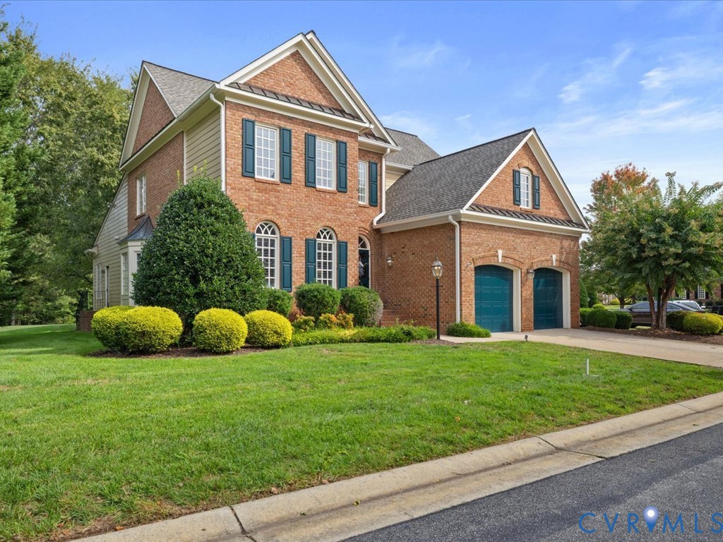 Brick exterior with gabled roof lines, white trim, and teal shutters Brick exterior with gabled roof lines, white trim, and teal shutters