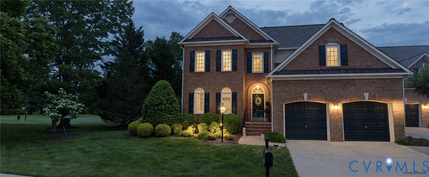 Brick exterior with a gabled roofline, two-car garage, and established landscaping