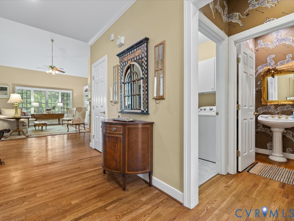 Hardwood flooring, vaulted ceiling, large windows, laundry appliance, pedestal sink