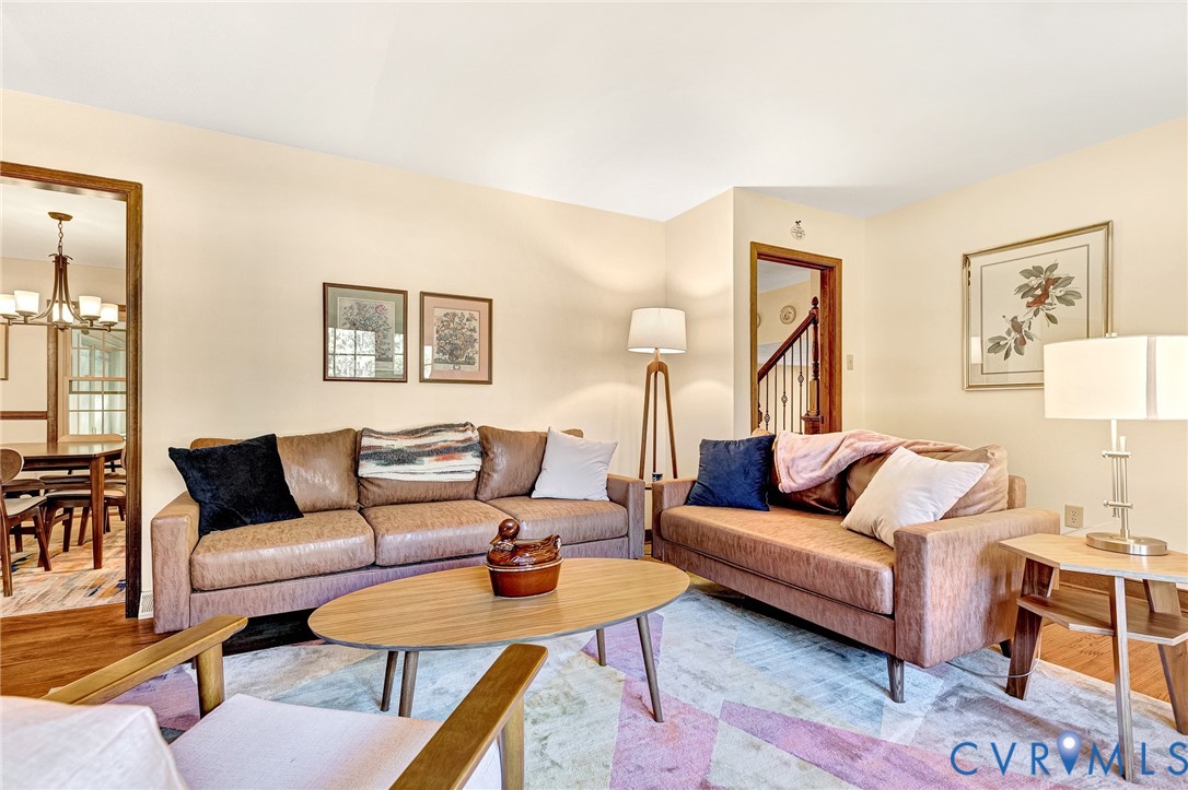Living area featuring wood-finish flooring and wood-trimmed door casings