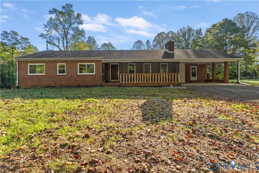 Brick exterior with a covered front porch featuring wood railing