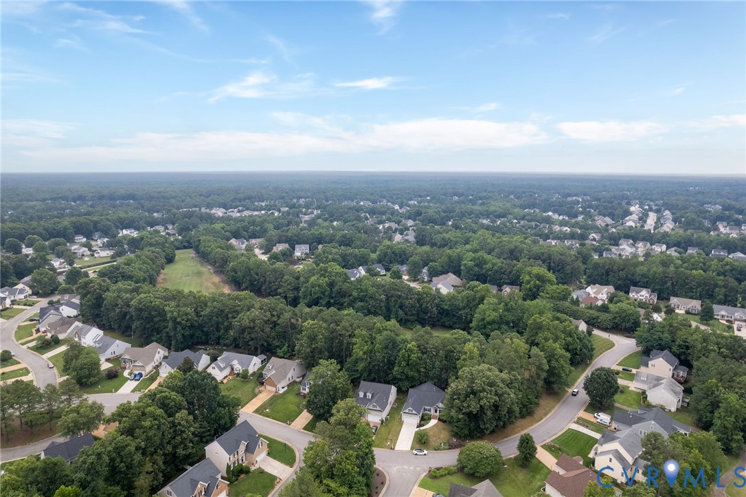 Aerial perspective featuring a residential cul-de-sac setting surrounded by mature tree lines and expansive natural foliage