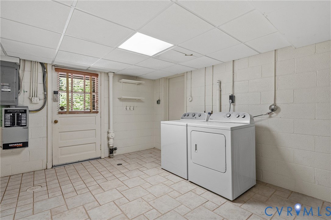Utility area featuring ceramic tile flooring, painted masonry walls, a suspended ceiling, and a paneled exterior door with integrated window