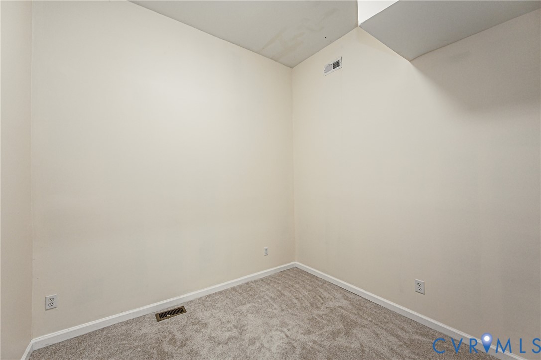 Interior space featuring neutral-toned carpeting and light-colored walls