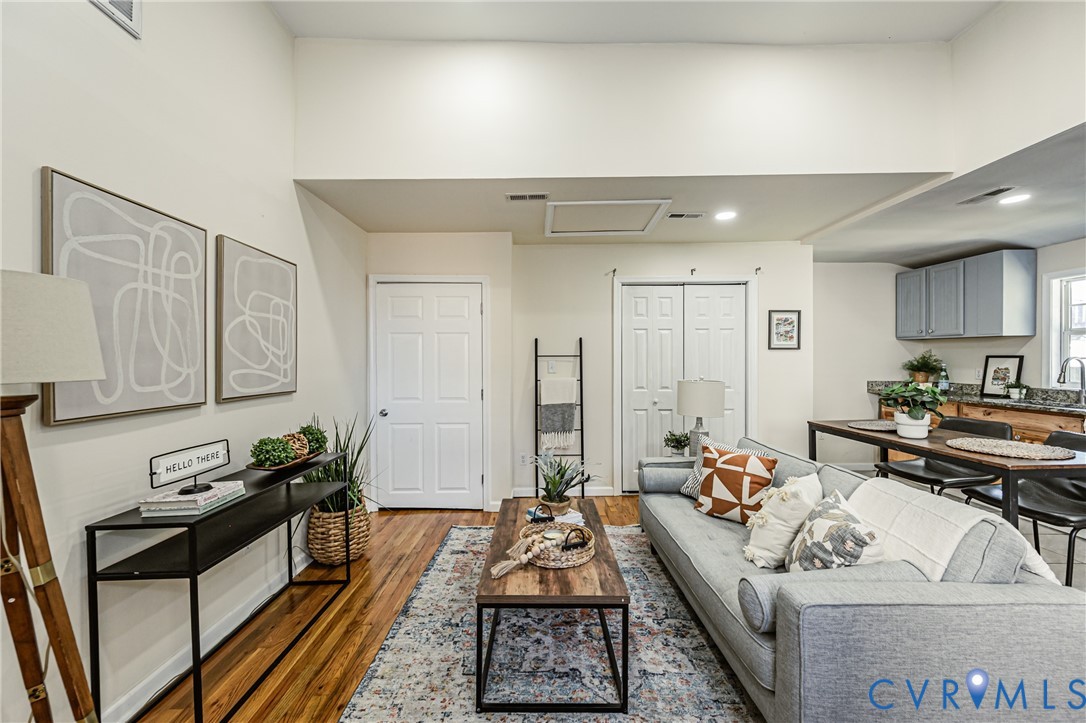 High-vaulted ceilings featuring recessed lighting, paired with wood-finish flooring and paneled interior doors