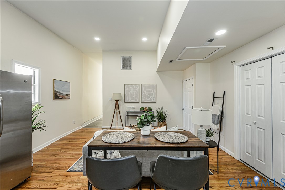 Interior space featuring vaulted ceilings, recessed lighting, and wood-finish flooring, complemented by six-panel interior doors and a dual-panel closet