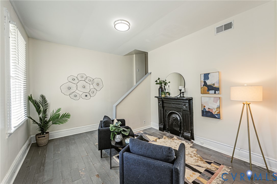 Interior space featuring wood-finish flooring, a decorative metal fireplace mantel, and recessed ceiling lighting