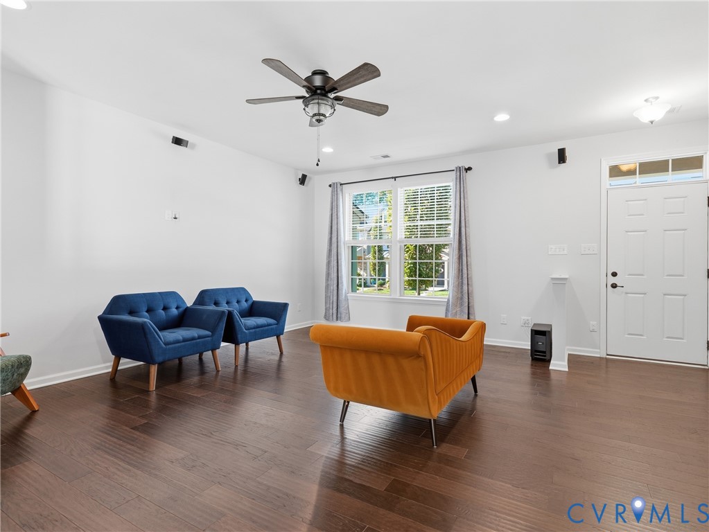 Welcoming living room with ample natural light and hardwood floors