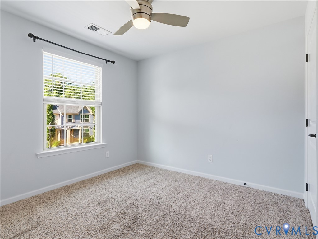Carpeted bedroom offers flexible space for overnight guests, hobbies, or a dedicated work area.