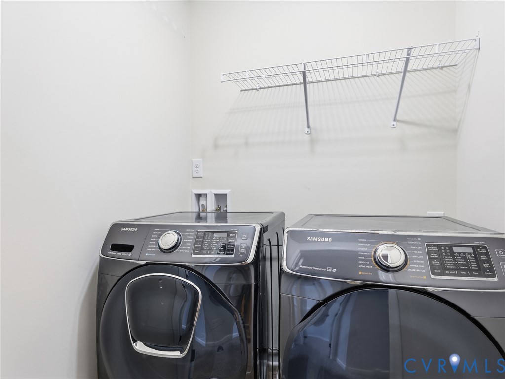 Functional laundry area with full size washer and dryer on the second floor