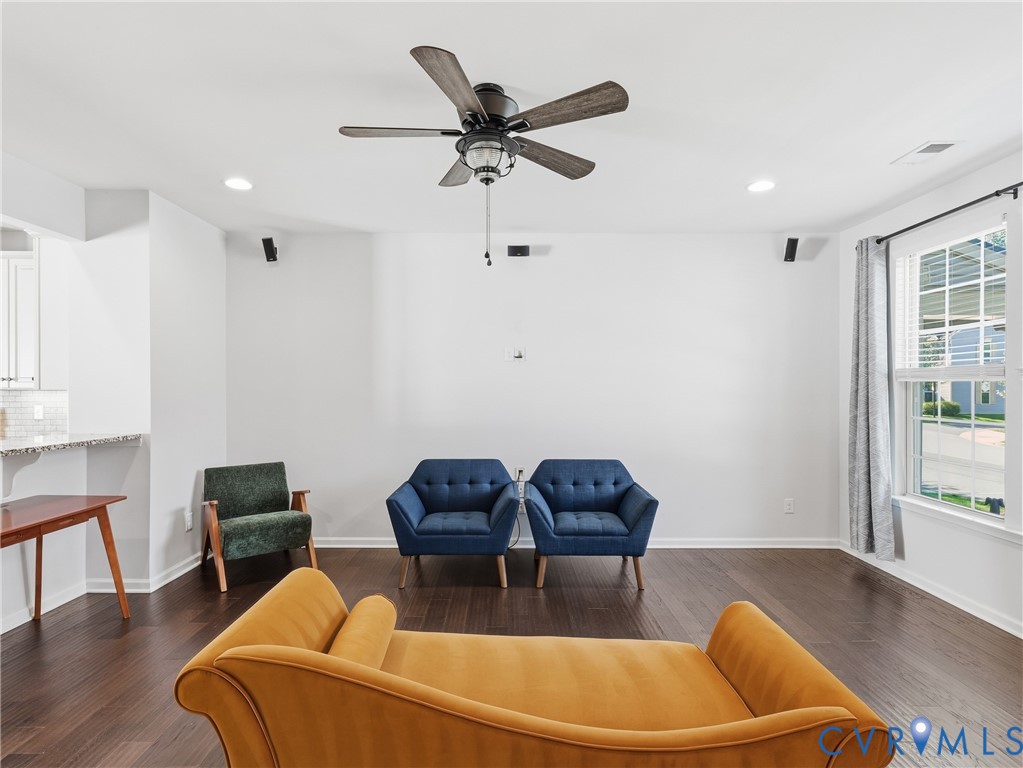 Open living area with updated ceiling fan and custom blinds, ideal for everyday comfort and entertaining at home.