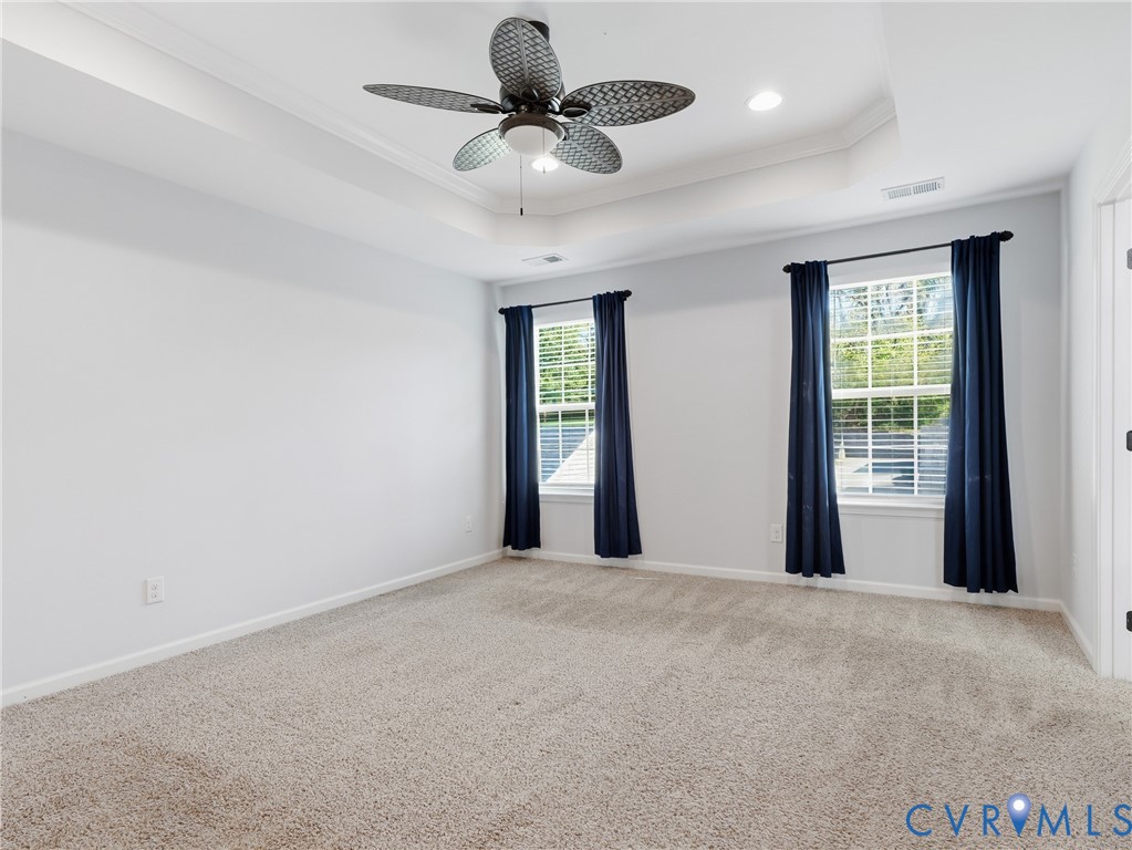 Top-level primary bedroom with large windows