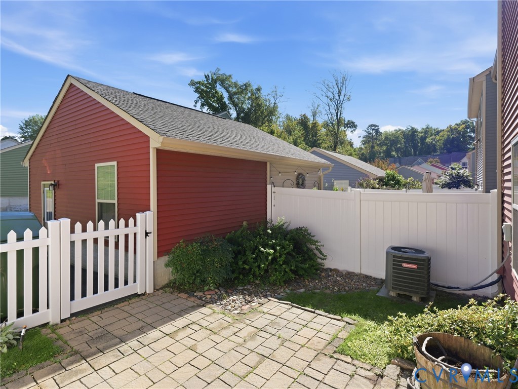 Rear outdoor area features brick pavers and room for patio furniture or an outdoor dining setup